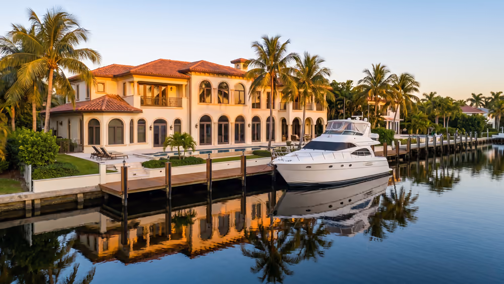 Canal-front home with a dock and yacht in Fort Lauderdale, Florida